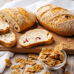 Side view on sliced muesli cereal bread on the wooden cutting board