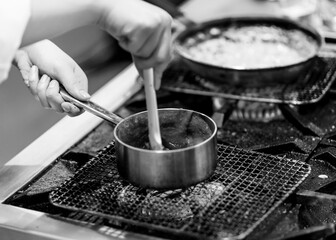 Chef cooking in a kitchen, chef at work, Black and White.