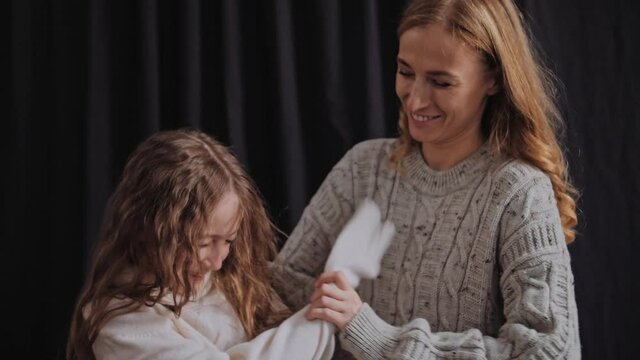 Happy mom and daughter fooling around. Happy Family concept in 4K slow motion