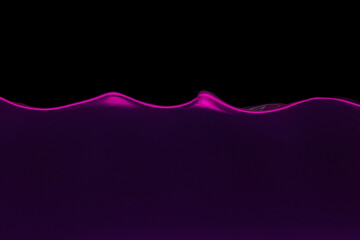 Waving water in aquarium in neon light against black background