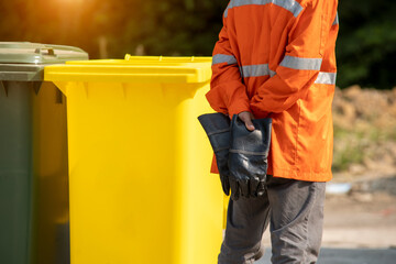 Garbage collection worker with Garbage collection truck working for a public utility.