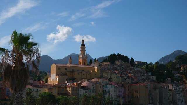 Menton during day and Saint Michel Archange Basilica in Cote d'Azur, (France). Cathedral, Catholic church in Provence Timelapse