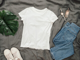 Fashionable look with white empty t-shirt, jeans and white sneakers. Top view of white blank...