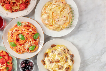 Italian pasta assortment. Spaghetti with tomato sauce and cheese, mushroom pappardelle, and other...