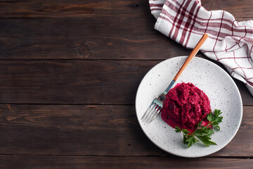 Salad of grated beetroot pine nuts and parsley with cream sauce on a plate. top view copy space