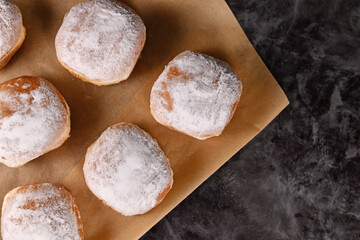 Top view of 'Berliner Pfannkuchen', a traditional German donut like dessert filled with jam made from sweet yeast dough fried in fat