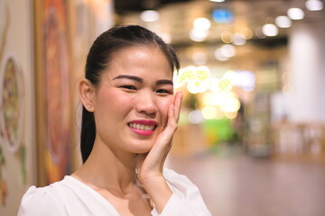 Portrait young woman cheerful shopping department store.