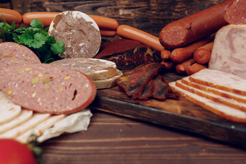 Variety of meat sausages on wooden board