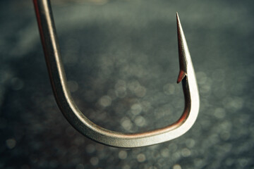 Macro photo of fishing hook on grey background