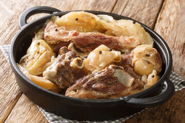 Norwegian cuisine lamb stew with cabbage and pepper in a pan on the table. Horizontal