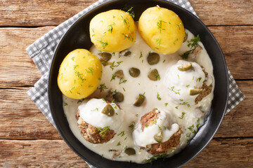 German Meatballs in Gravy with capers Konigsberger Klopse close-up in a plate on the table. Horizontal top view above