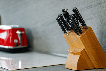 Set of knives on stand on kitchen counter