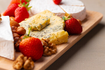 Composition of cheese, and fruits on gray table
