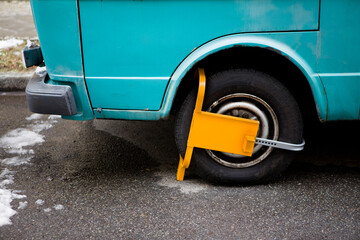 The wheel of the car is blocked by the wheel lock