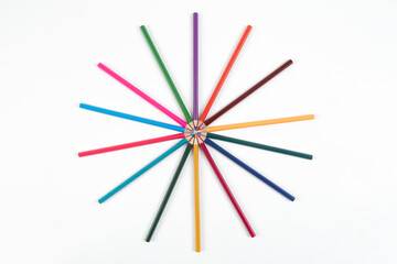 Fototapeta premium Circle made of colorful pencils on blue background