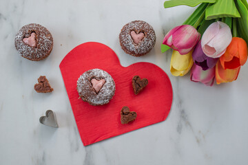 Fototapeta na wymiar Chocolate Cupcakes decorated with sugar hearts for Valentines Day
