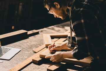 Carpenter man woodcraft working in furniture wood workshop with professional skill real people workman.