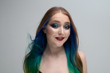 Caucasian girl with long dyed hair. Photo portrait of a model with excellent makeup.