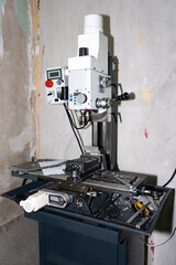 A milling machine for metal in a technical room.