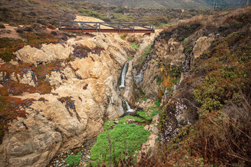 Fototapeta na wymiar Beautiful landscape of a small waterfall in Garrapata State Park, on the hiking trails of Point Soberanes, California, USA