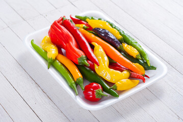 chili pepper selection on white wood table background