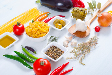 traditional italian food ingredients on white wood table