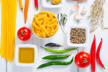 traditional italian food ingredients on white wood table