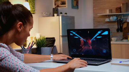 Angry professional gamer because it's game over for her during an online championship. Champion player testing online video games on her personal computer with modern technology network wireless. © DC Studio