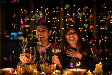 Obraz na płótnie Canvas young couple celebrate at night party, romance date and love concept for Valentine's Day, dinner with night candle light, cozy with couple family at home