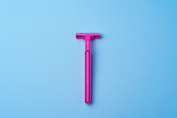 Single disposable razor for women on blue background