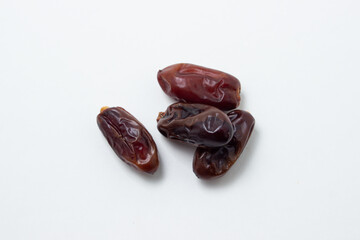 Dates on a white background. Dried fruits. Dried dates lie next to each other
