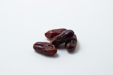 Dates on a white background. Dried fruits. Dried dates lie next to each other