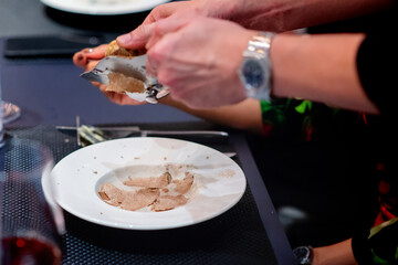 Obraz na płótnie Canvas chef sprinkle sliced truffle on soup