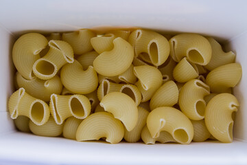 fresh raw durum pasta in white box in kitchen