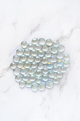 set of clear pebbles. beautiful glass marbles on abstract background. spiritual practice, life...