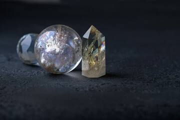 quartz ball and citrine stones mineral on black abstract  background close up. Crystal Ritual,...