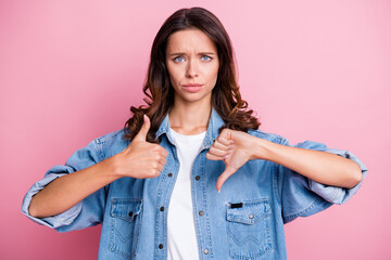 Photo of upset young woman show thumb up thumb down bad mood isolated on pastel pink color background - obrazy, fototapety, plakaty