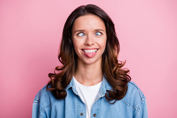 Photo of fooling cheerful cute young woman stick out tongue grimace isolated on pastel pink color...