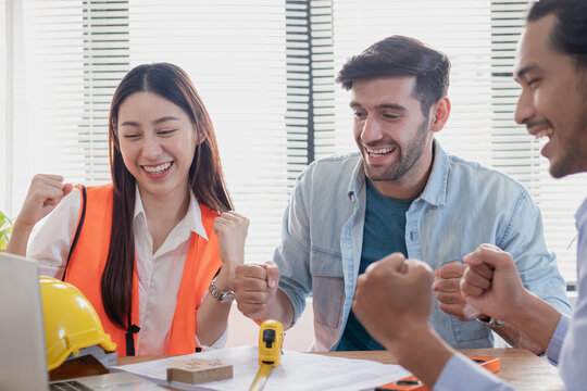 Team business people of cheer up, cheer up, smill young caucasian, asian contractor, engineer colleague celebrated about job, with coworker, partner at workplace. Business success concept..