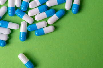 white and blue pills on yellow background