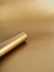 Gold paper rolled up in a tube, in a circle, abstract background for the design