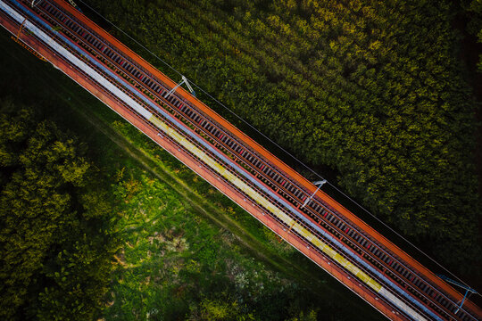Aerial view of train rail road crossing the countryside near Flaca township, Girona, Spain.