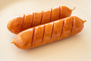 Grilled sausages on a white plate
