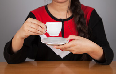 Young woman drinking black coffee.