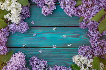 Lilac flowers on a wooden background as a frame, idea, concept backdrop texture.