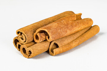 Fragrant cinnamon sticks on a white background.