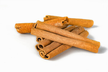 Fragrant cinnamon sticks on a white background.
