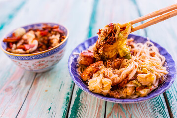 Tasty teriyaki chicken with chow mein noodles and kimchi.