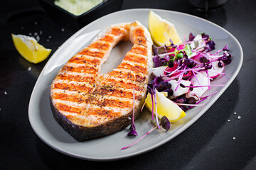 Salmon. Salmon fish steak grilled and radish salad with microgreens. Healthy food.