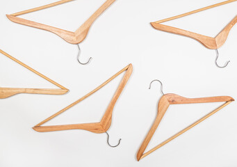 Clothes hangers made of wood on a light background. Hangers made of environmentally friendly material